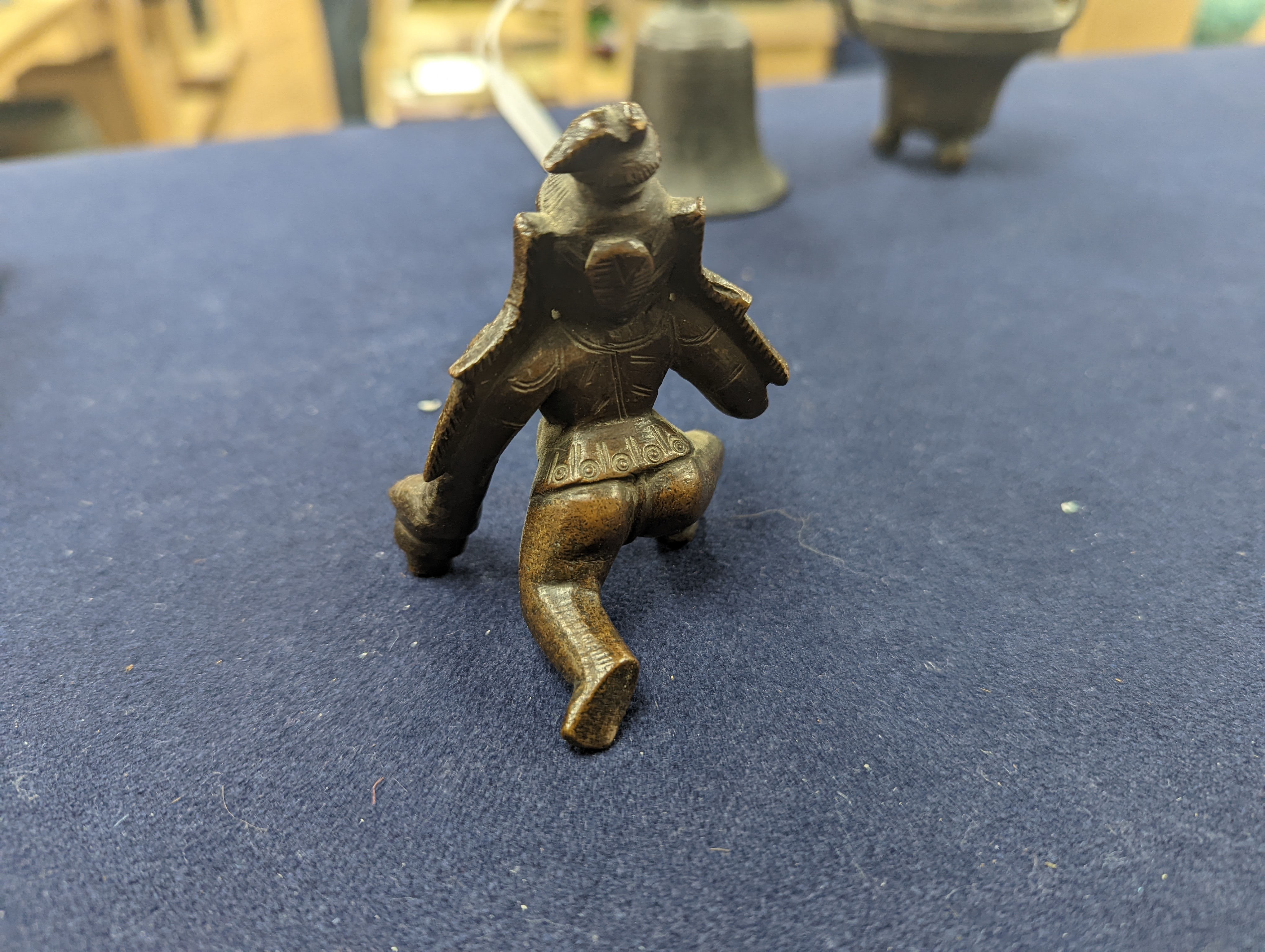 A Chinese gilt copper figure, a Chinese Dog of Fo, a bell, a censer, six Indian bronze figures and a scroll box